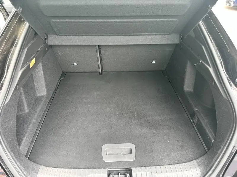 Coffre ouvert vu de dessus du Renault Arkana noir métal, espace de chargement propre et spacieux.