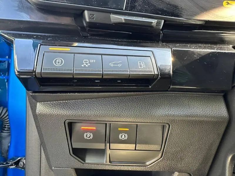 Gros plan sur les commandes de fonctions électroniques côté gauche du tableau de bord d'une Renault Rafale bleu sommet métallisé.