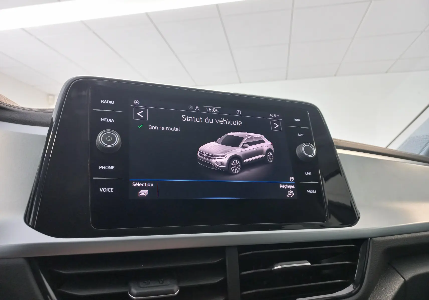 Écran central affichant le statut du Volkswagen T-Roc gris Indium 2025, vue intérieure du tableau de bord.
