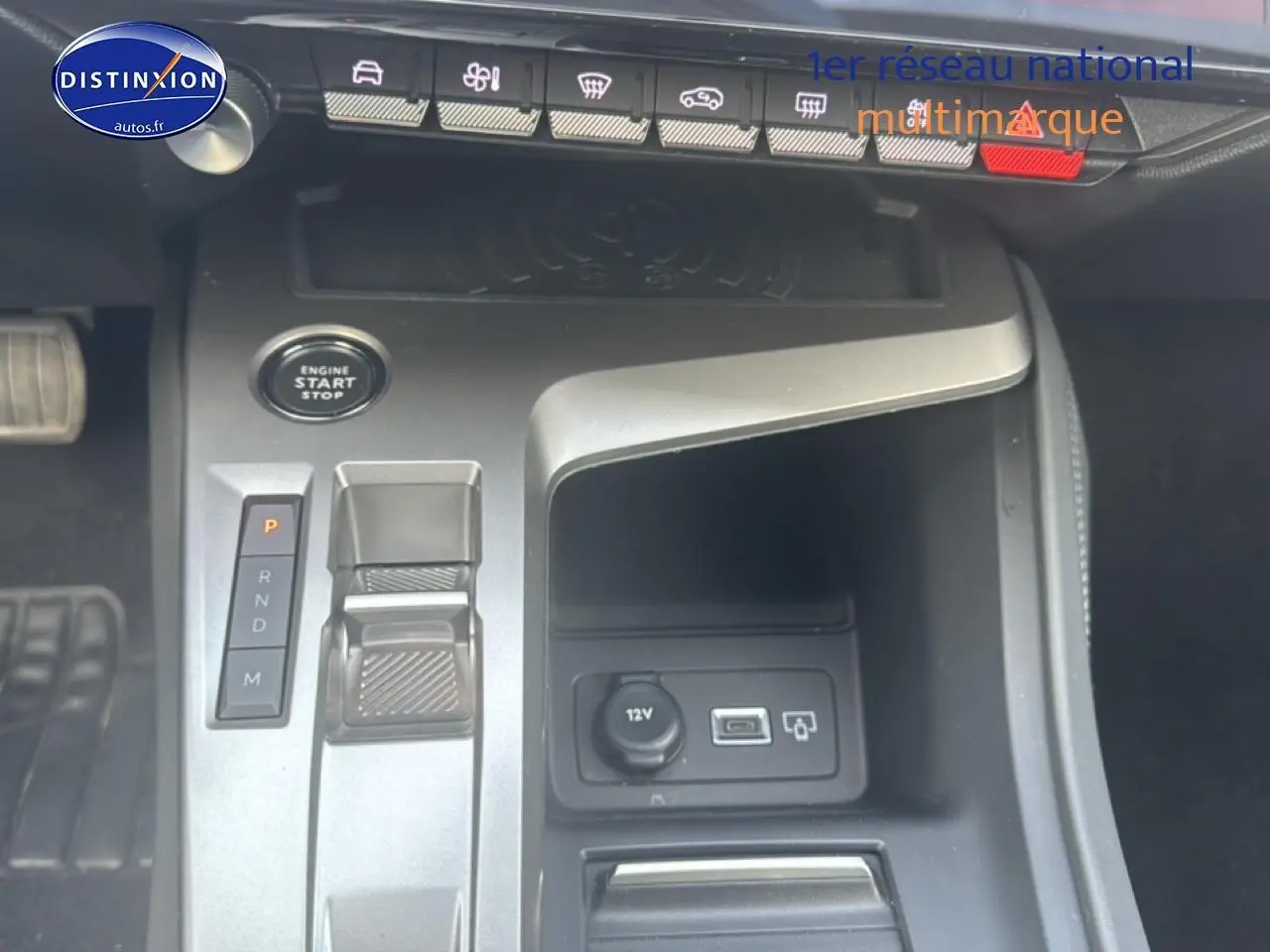 Vue rapprochée de la console centrale grise de la Peugeot 308 2024 avec bouton start/stop et commandes de boîte auto.