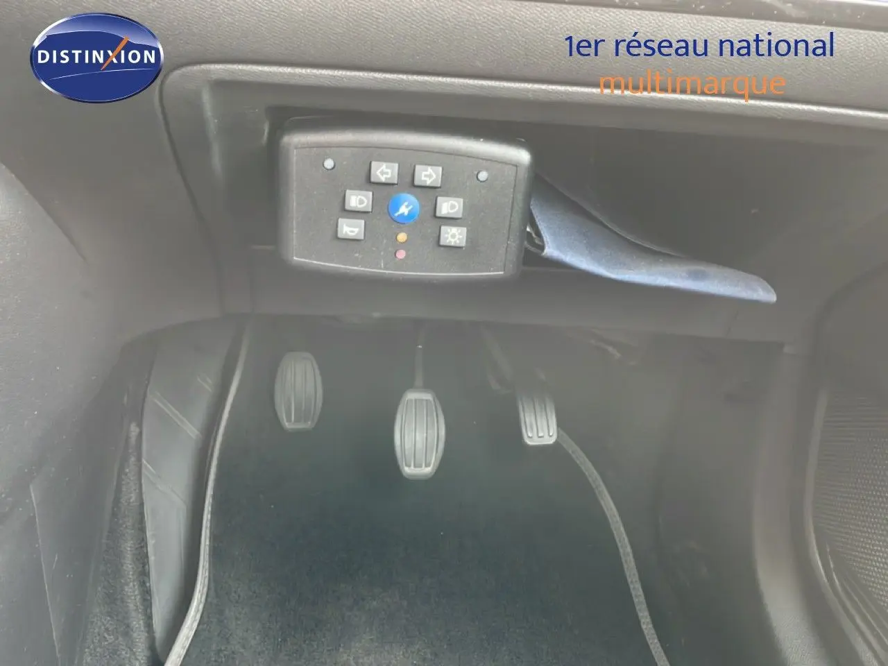 Vue rapprochée des pédales d’embrayage, frein et accélérateur d’une Peugeot 208 rouge Elixir Metal avec boîte manuelle.