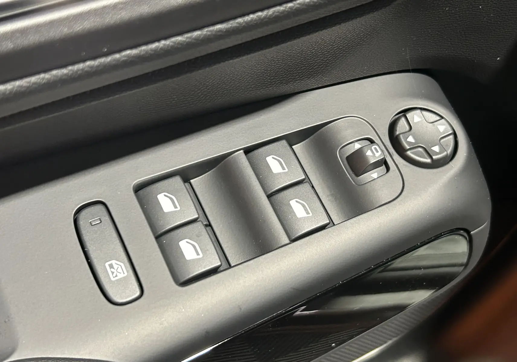 Gros plan sur les commandes des vitres électriques côté conducteur du Citroën C5 Aircross gris platinium 2025.
