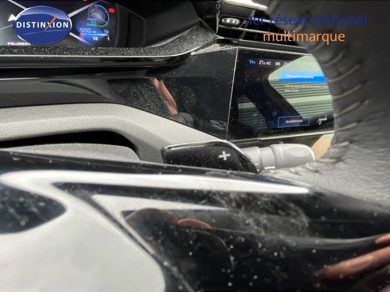 Vue rapprochée du tableau de bord et du volant noir du Peugeot 408 gris Selenium, avec affichage numérique et commandes au volant.