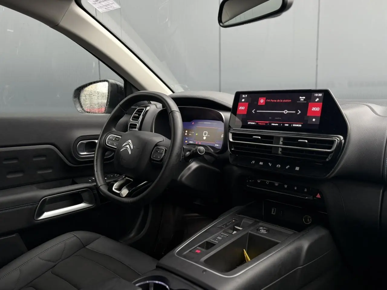 Vue intérieure côté conducteur du Citroën C5 Aircross Hybrid 2024, tableau de bord noir avec écran tactile 10 pouces.