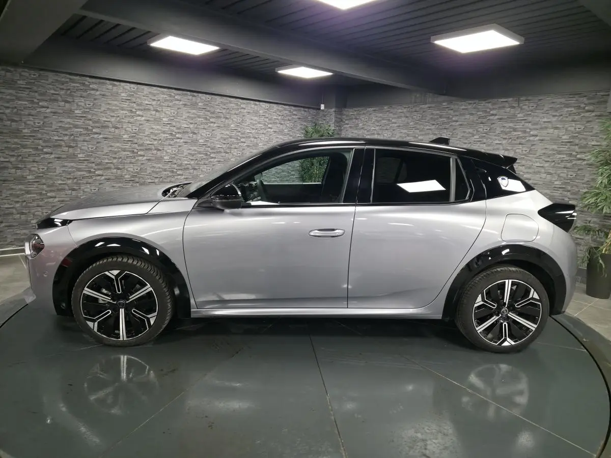 Vue de profil côté gauche d'une Lancia Ypsilon 2025 gris métallisé avec toit noir et jantes alliage 17 pouces.