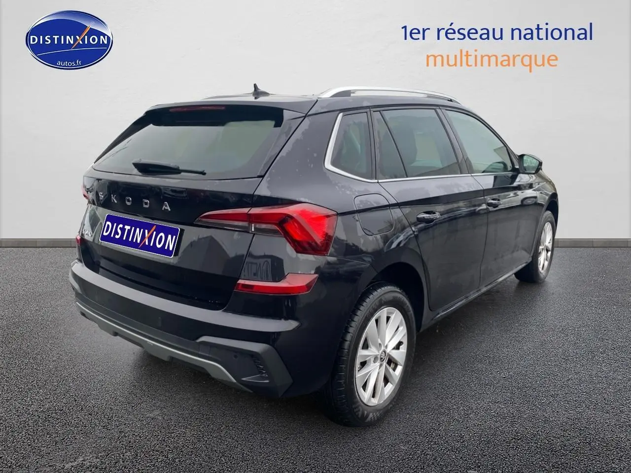 Vue 3/4 arrière droite d'un Skoda Kamiq noir avec barres de toit et feux arrière LED distinctifs.