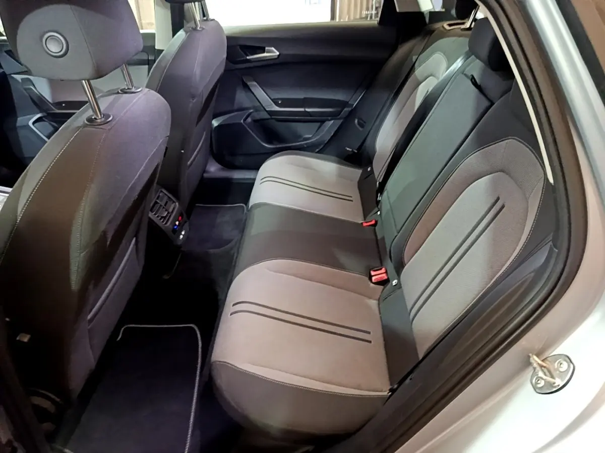 Vue intérieure côté droit montrant la banquette arrière grise et noire du SEAT LEON 2022 avec portes ouvertes.