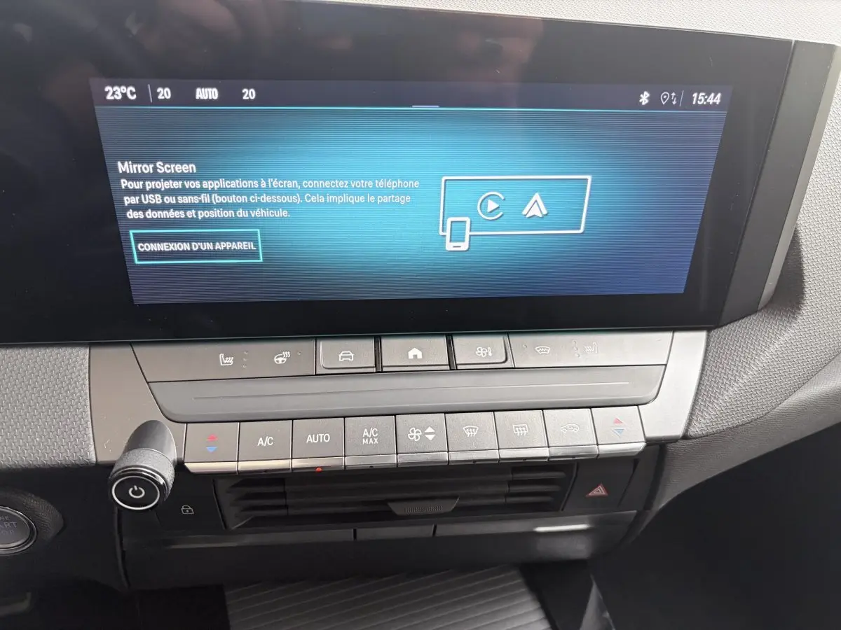 Vue rapprochée de l’écran tactile central et des commandes de climatisation de l’Opel Astra blanche 2024.