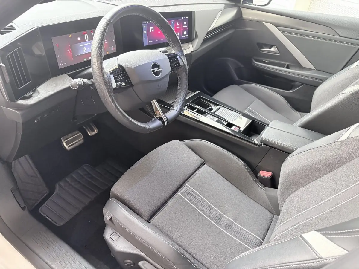 Vue intérieure côté conducteur de l'Opel Astra 2024, volant cuir multifonctions et tableau de bord digital.