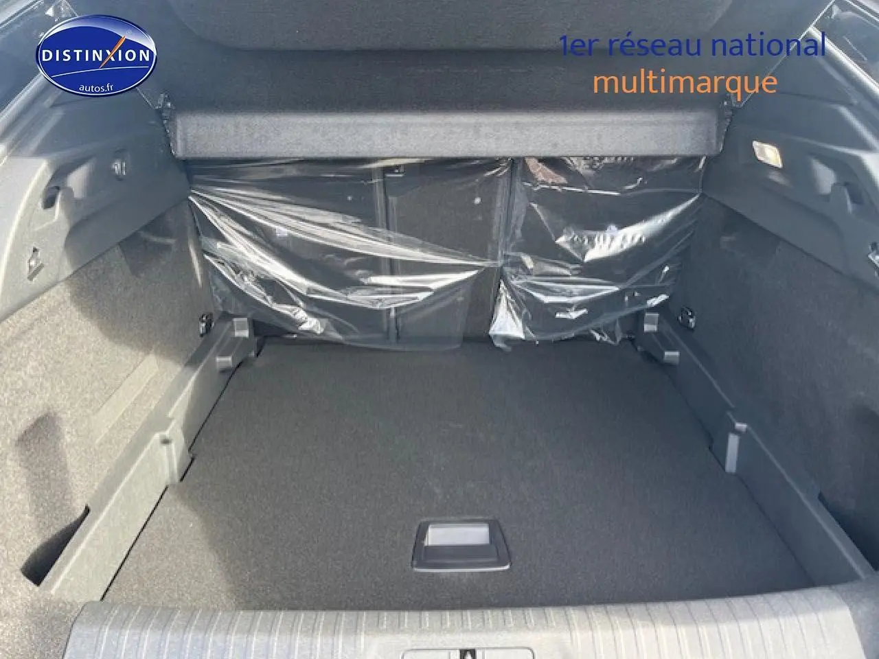 Coffre spacieux de Peugeot 3008 gris Artense vu de l'arrière, avec banquette arrière protégée par film plastique.