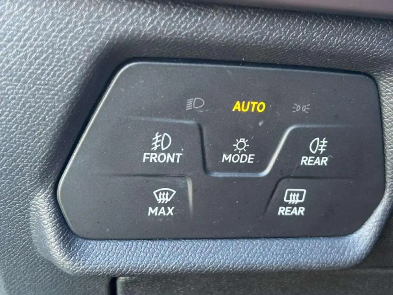 Panneau de commande des feux et dégivrage avec indication AUTO sur un CUPRA Formentor blanc, vue intérieure détail.