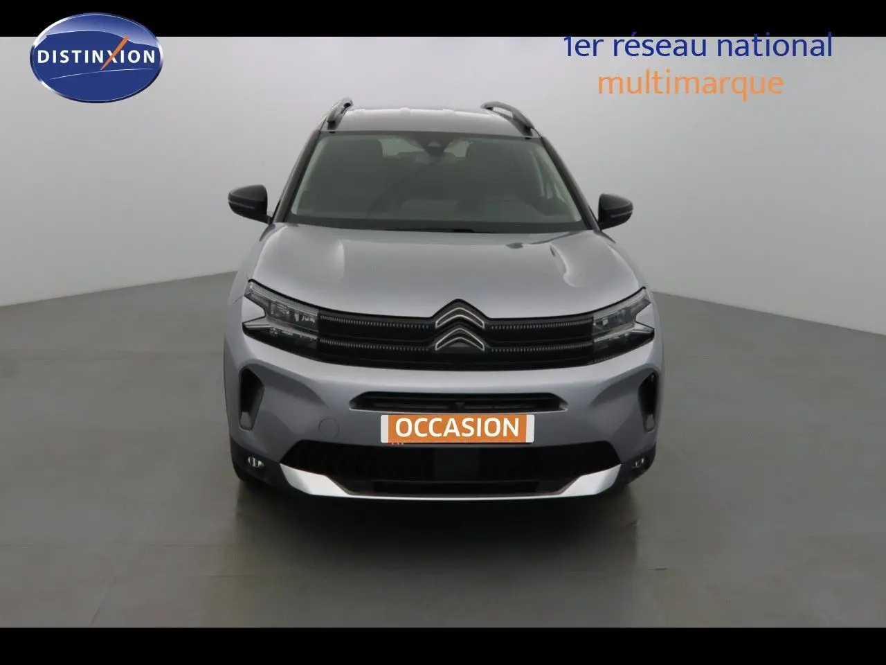 Vue 3/4 arrière gauche d'un Citroën C5 Aircross gris Artense métal avec toit noir et jantes bicolores.