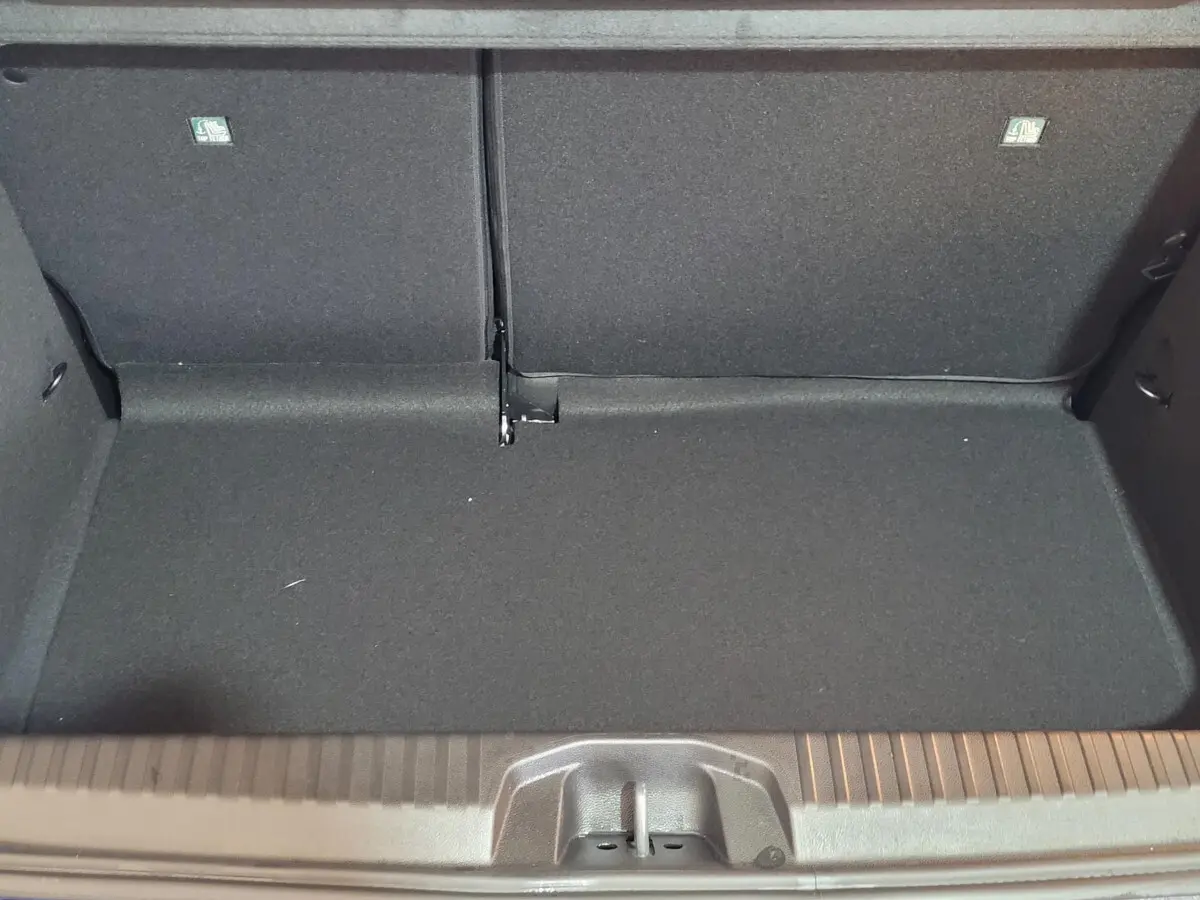 Coffre ouvert de la Renault Clio Evolution Blue dCi 100 2025, vue intérieure, revêtement noir uniforme.