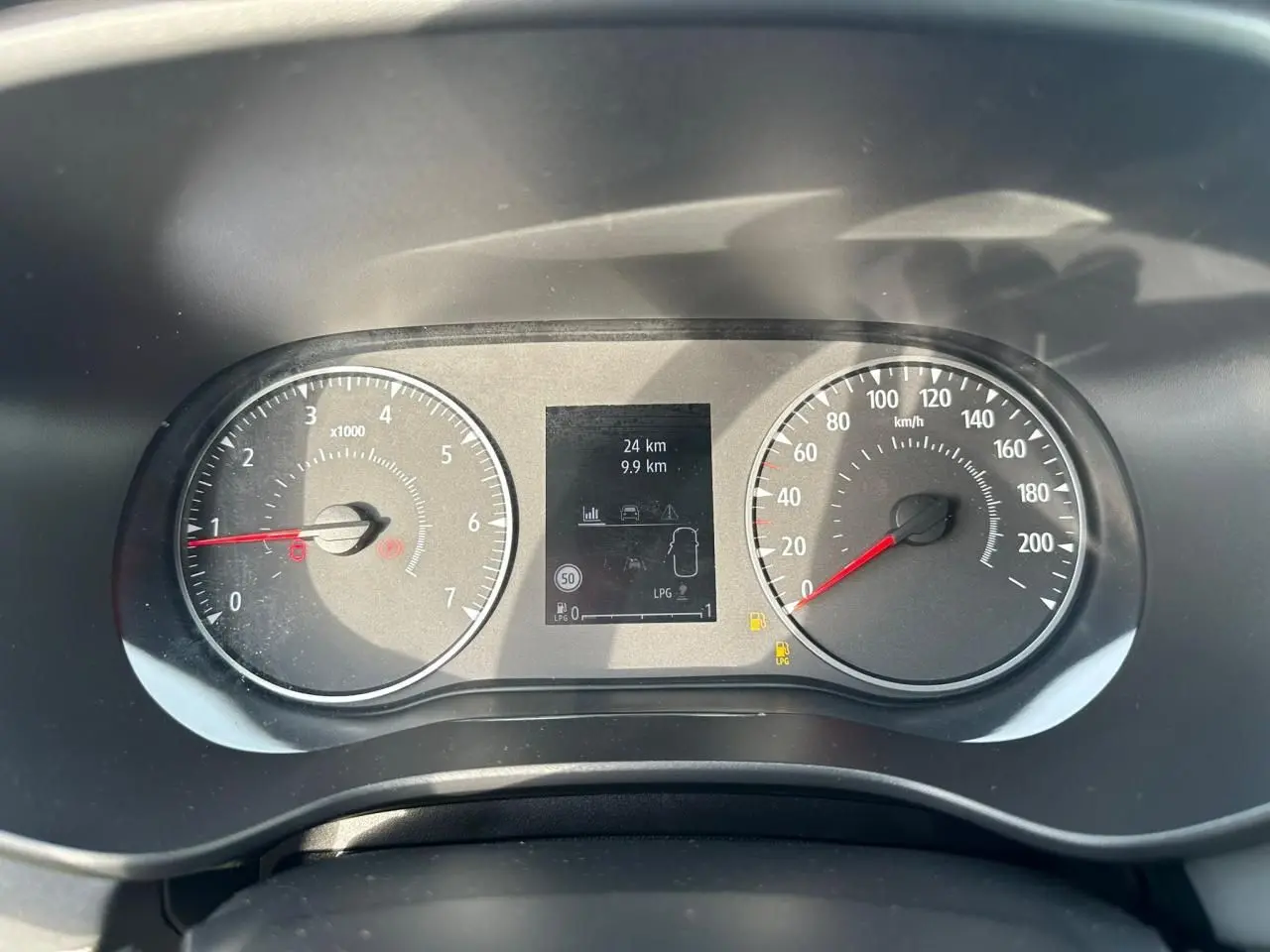 Tableau de bord de Dacia Sandero III Stepway, vue frontale sur compteurs analogiques et écran numérique central.