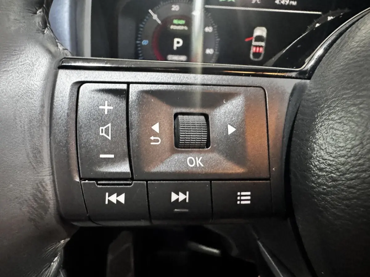 Gros plan sur les commandes multifonctions noires au volant du Nissan Qashqai e-Power 190 Tekna BVA 2023.