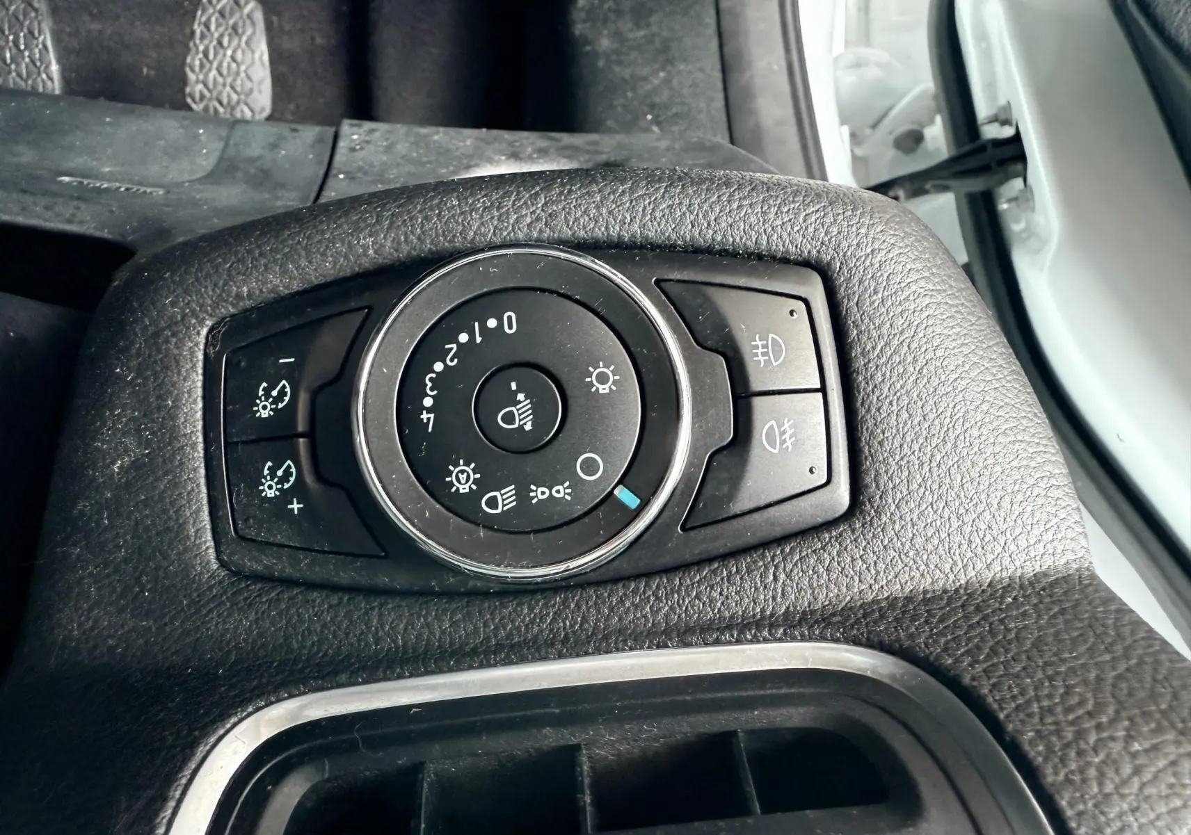 Gros plan sur le sélecteur d'éclairage noir dans l'habitacle côté gauche d'une Ford B-MAX blanche de 2014.
