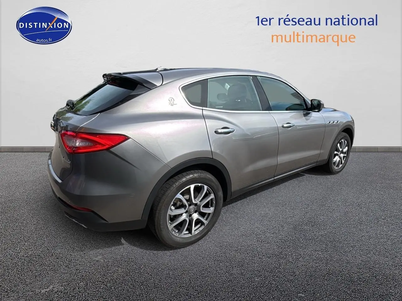 Vue 3/4 arrière droite d'un Maserati Levante gris métallisé avec jantes alliage et feux arrière LED.