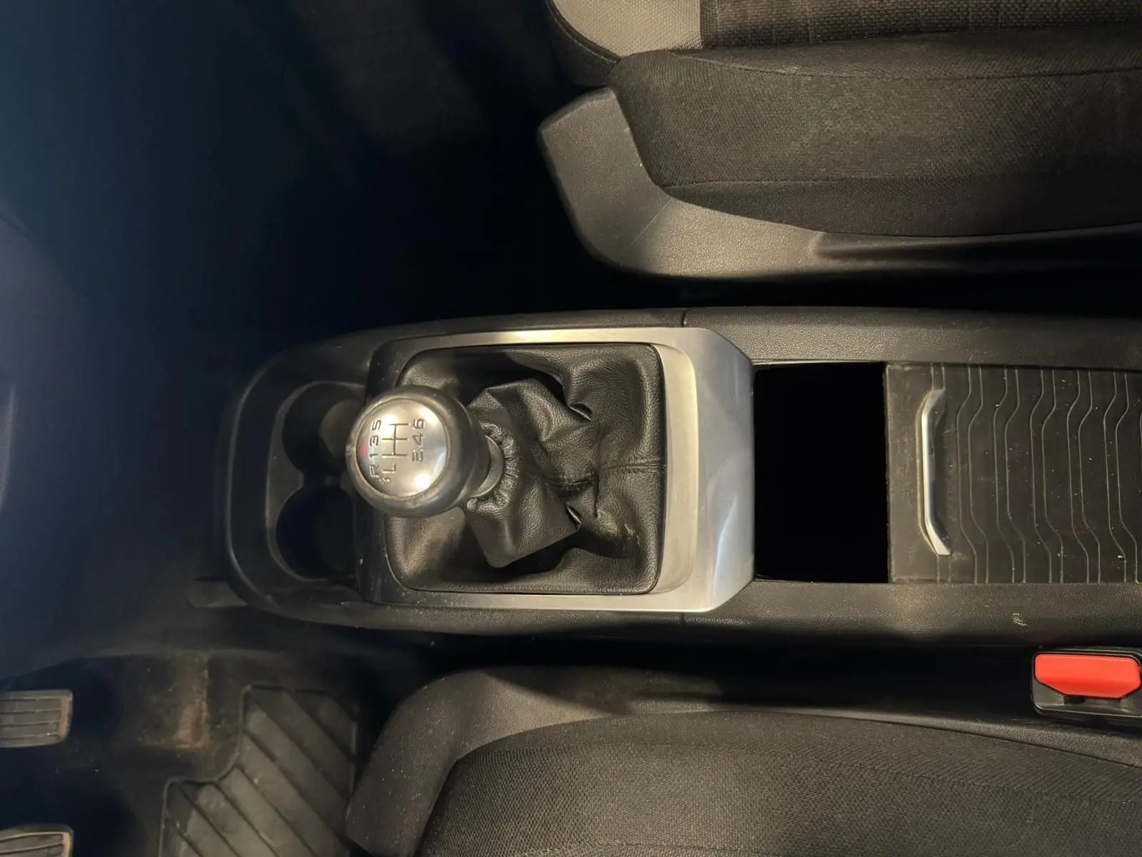 Vue intérieure centrée sur le levier de vitesse manuel en cuir noir de la Citroën C4 Picasso 2016, avec console centrale grise.