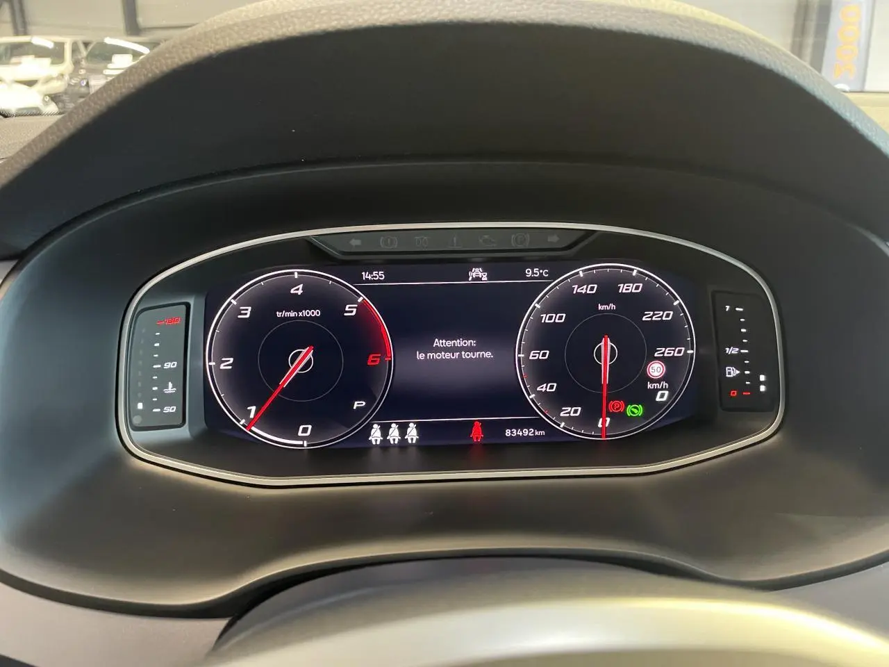 Tableau de bord numérique du SEAT Ateca 2022 affichant compte-tours, vitesse et alertes, vue de face intérieure.