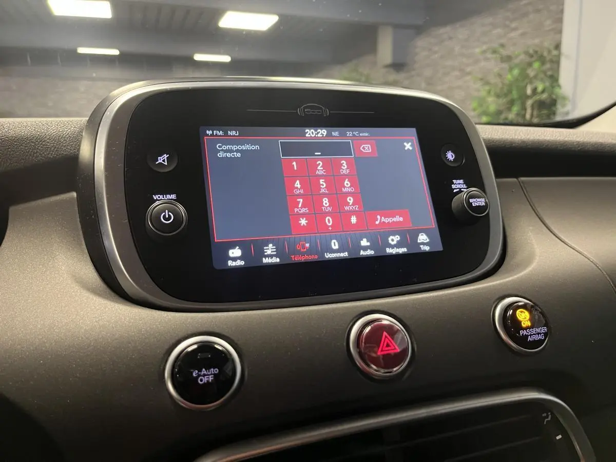 Vue rapprochée de l’écran tactile central du tableau de bord gris titane de la Fiat 500X 2024.