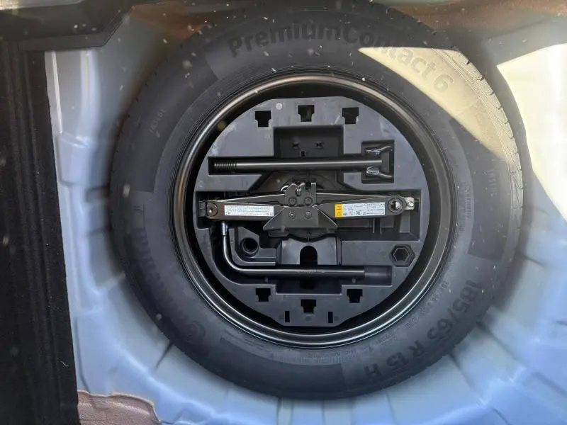 Roue de secours avec outillage intégré dans le coffre d'une Renault Clio 1.0 TCe 90ch Techno 2025 Bleu Iron.