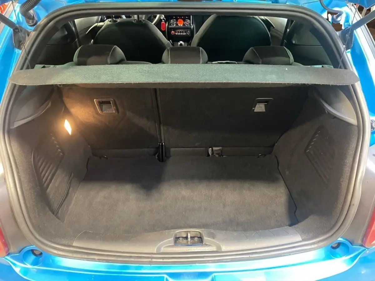 Coffre ouvert vu de l'arrière d'une Citroën DS3 bleu 2011, montrant l'espace de chargement et la tablette arrière.