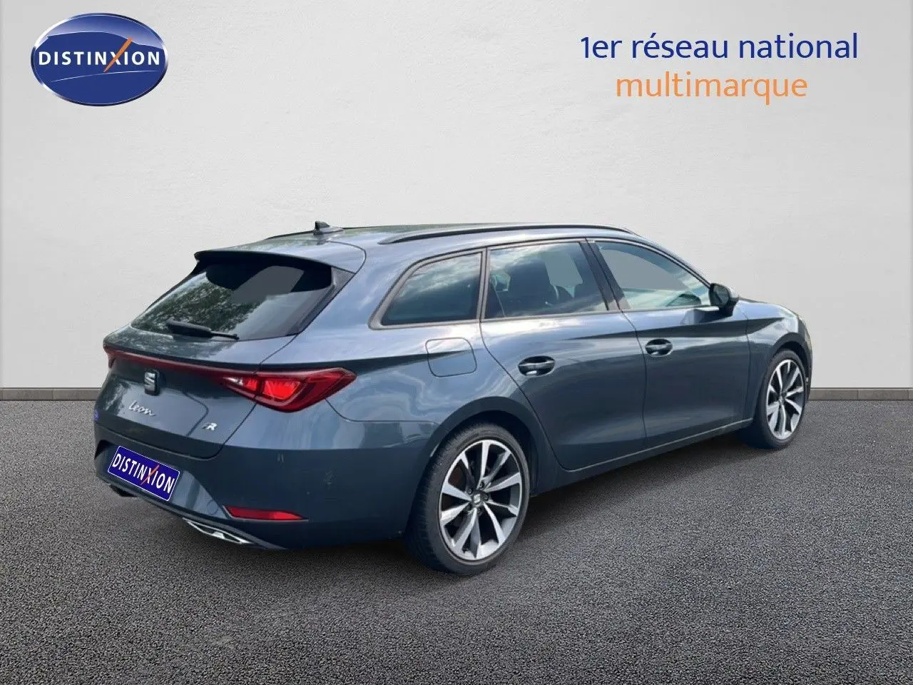 SEAT Leon ST gris magnétique vue 3/4 arrière droit, break hybride essence avec jantes alliage distinctives.