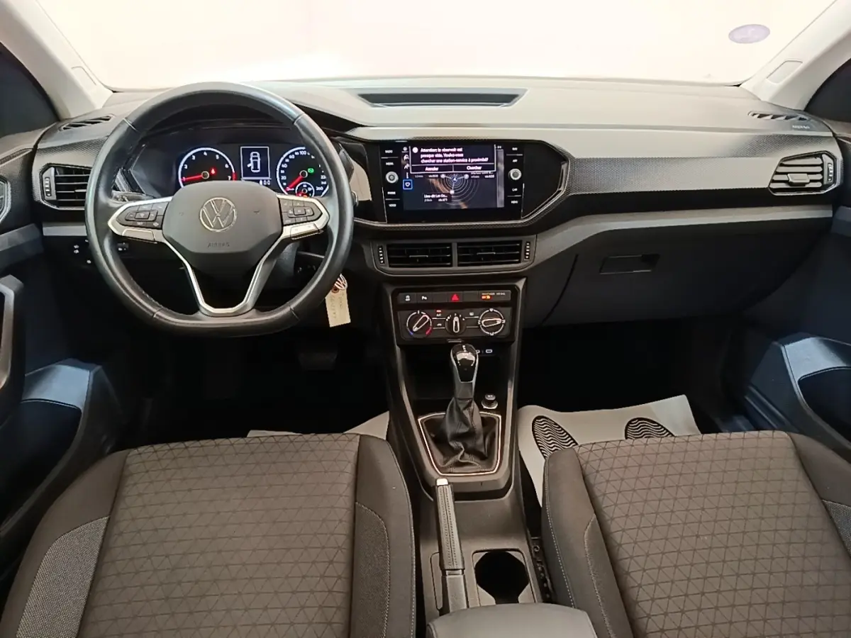 Vue intérieure frontale du tableau de bord et volant cuir multifonctions du Volkswagen T-Cross 2022.