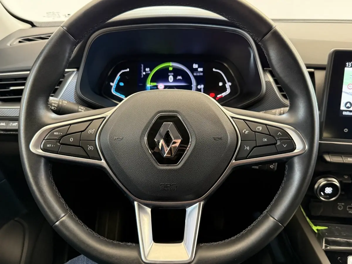 Vue rapprochée du volant en cuir et alu de la Renault Arkana Business E-TECH 145 avec tableau de bord numérique.