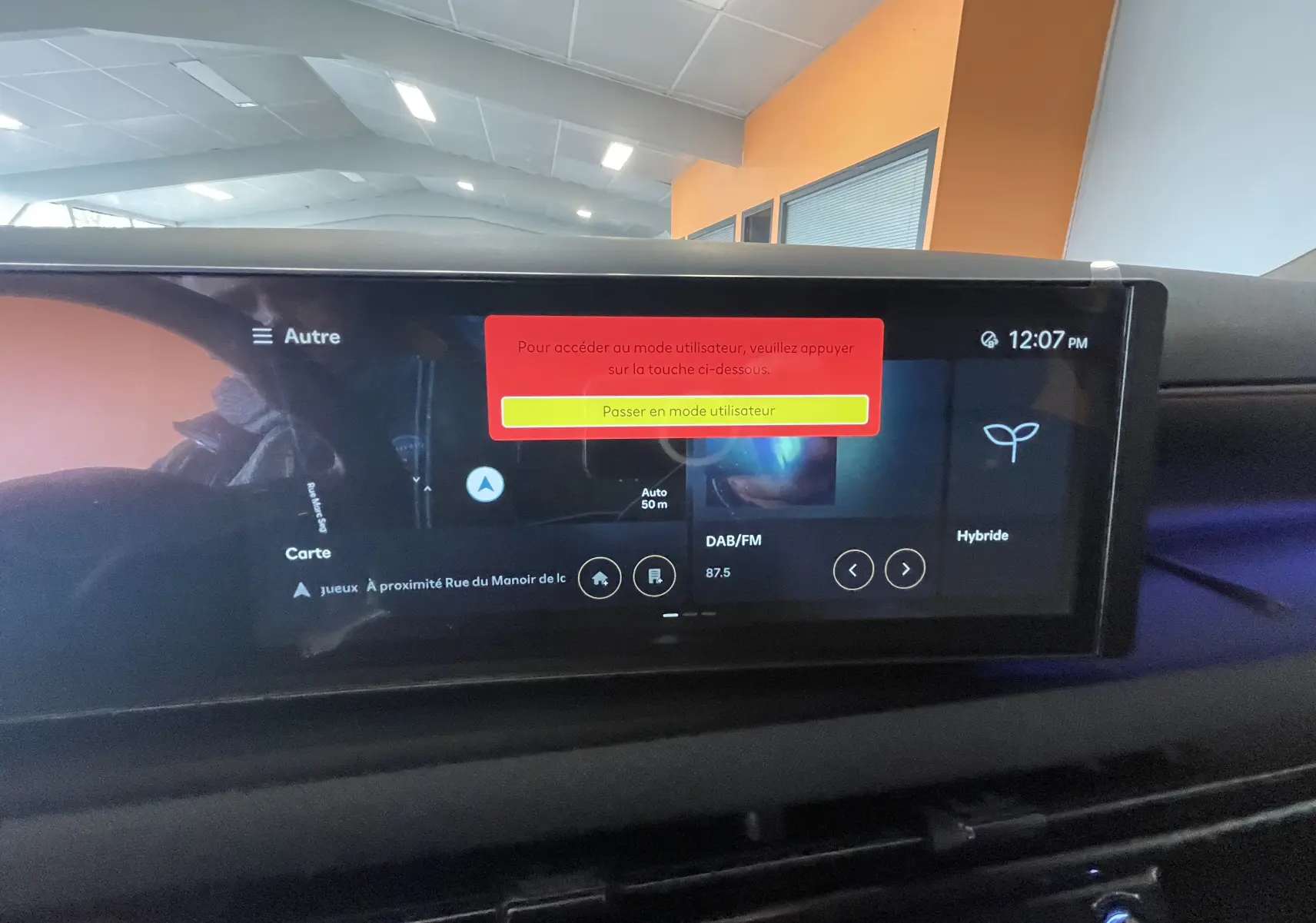 Écran tactile central du tableau de bord du Hyundai Tucson gris Ecotronic 2025 affichant la navigation et mode hybride.