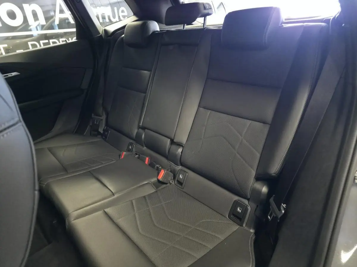 Vue intérieure sur la banquette arrière en similicuir noir perforé de la BMW Série 2 Active Tourer 218i 2023.