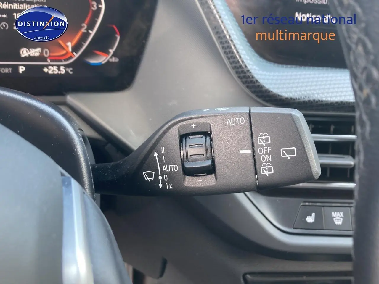 Gros plan sur la commande des essuie-glaces à gauche du volant dans l’habitacle d’une BMW Série 1 gris foncé 2023.