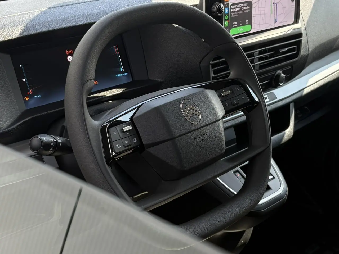 Gros plan sur le volant multifonction noir du Citroën Jumpy 2026 avec tableau de bord numérique et écran tactile intégré.