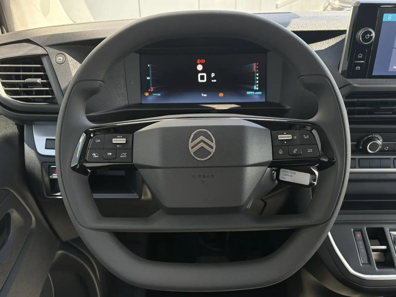 Vue intérieure centrée sur le volant noir du Citroën Jumpy 2026 avec tableau de bord numérique et écran tactile.