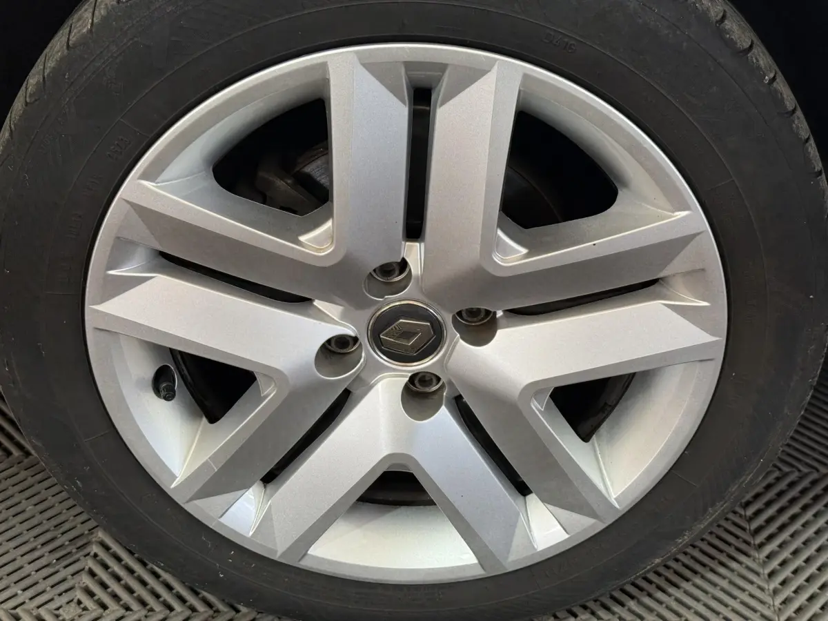 Gros plan sur la roue avant avec jante argentée au design moderne et logo Renault central visible.