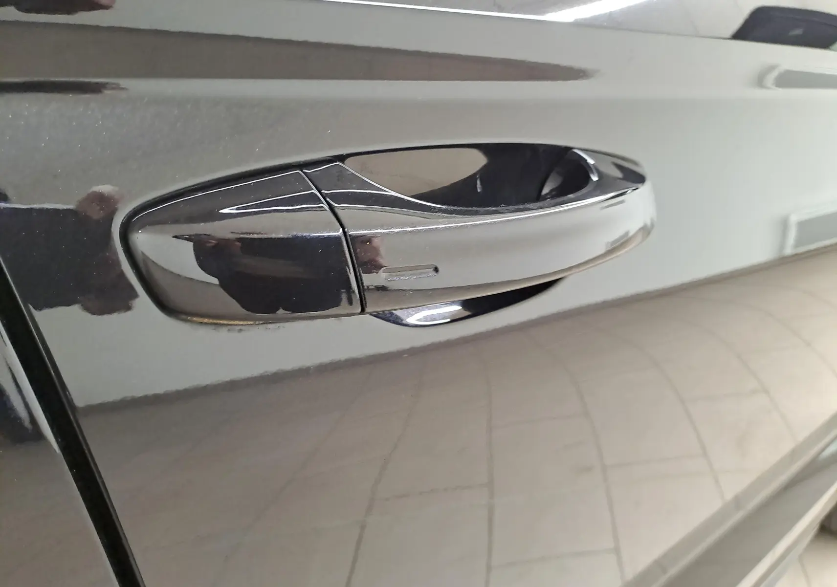 Poignée de porte noire brillante du côté gauche d'une CUPRA Ateca 2024 en finition Noir Magique.