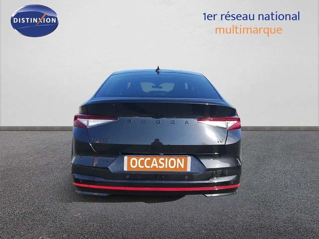 Vue arrière d'une Skoda Enyaq Coupé noire métal avec feux LED et bande rouge distinctive sur le pare-chocs.