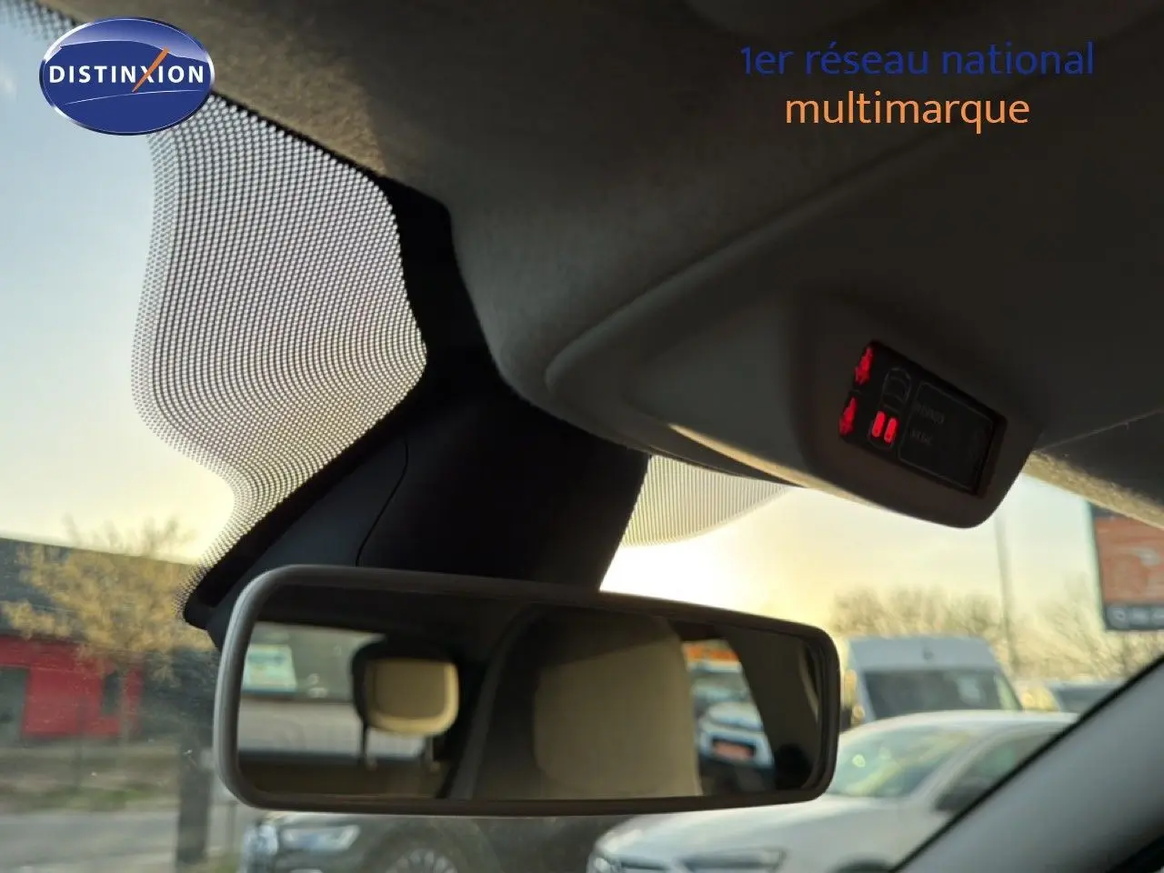 Vue intérieure du rétroviseur central d'une Renault Twingo gris acier, avec affichage des ceintures de sécurité au plafond.