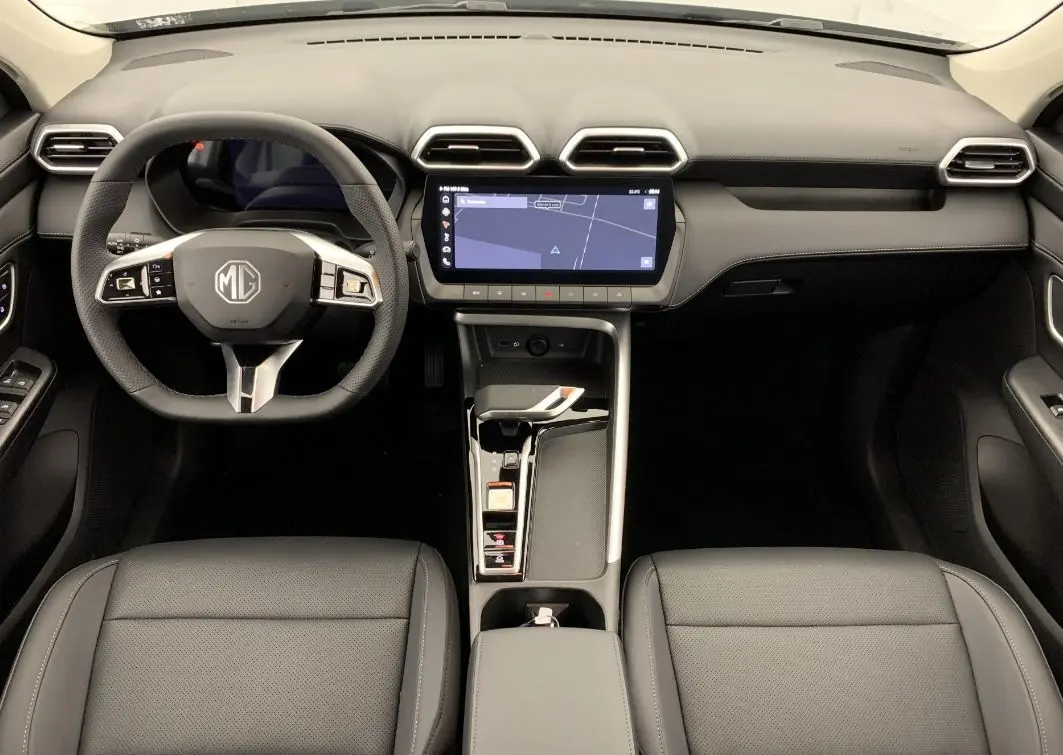 Vue intérieure frontale du tableau de bord et volant noir du MG ZS 1.5 L HYBRID+ 197 CH LUXURY avec écran tactile central.