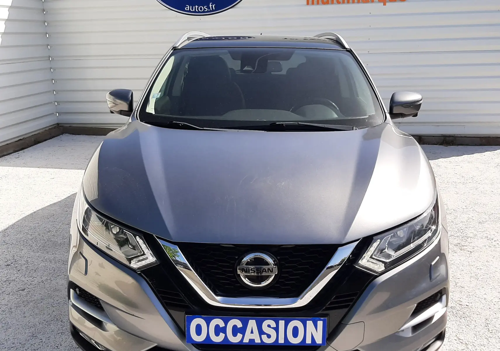 Vue avant d'un Nissan Qashqai marron métal 2018 avec calandre chromée et plaque "OCCASION" visible.