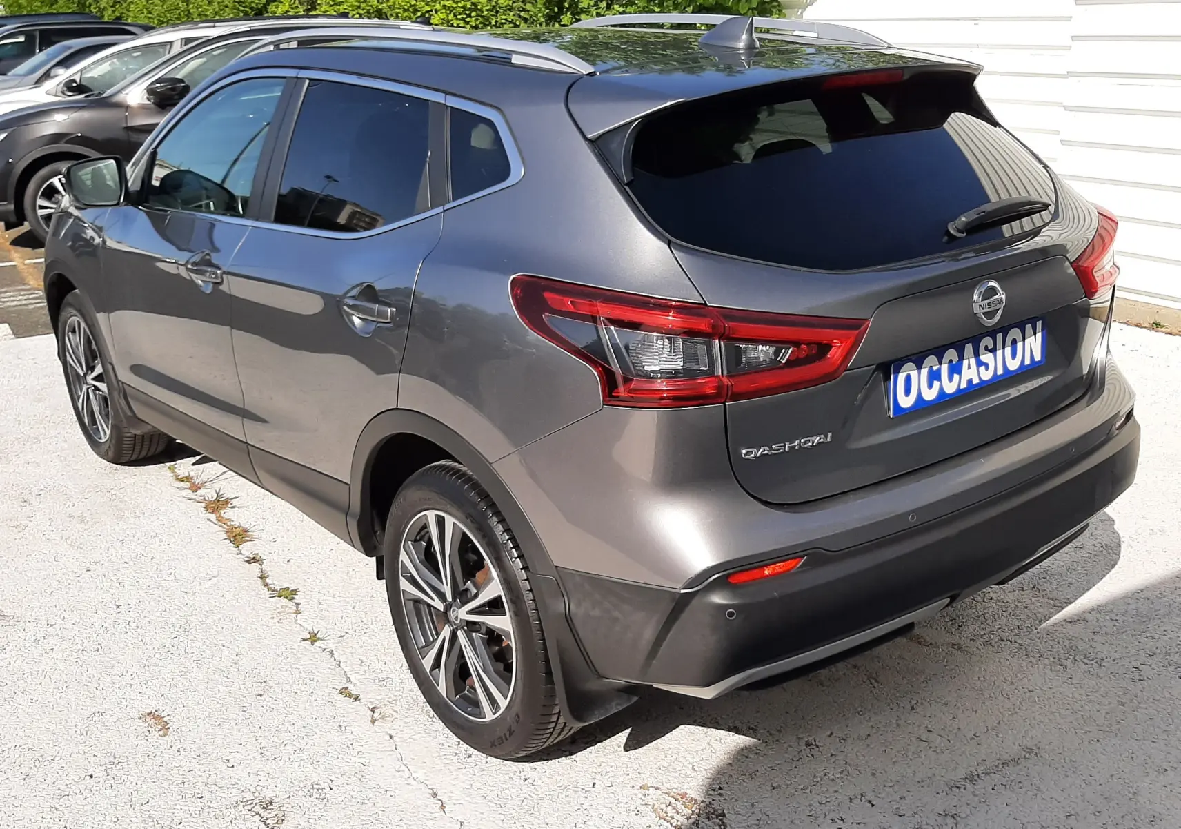Vue 3/4 arrière droite d'un Nissan Qashqai marron métal 2018 avec jantes alliage et vitres teintées.