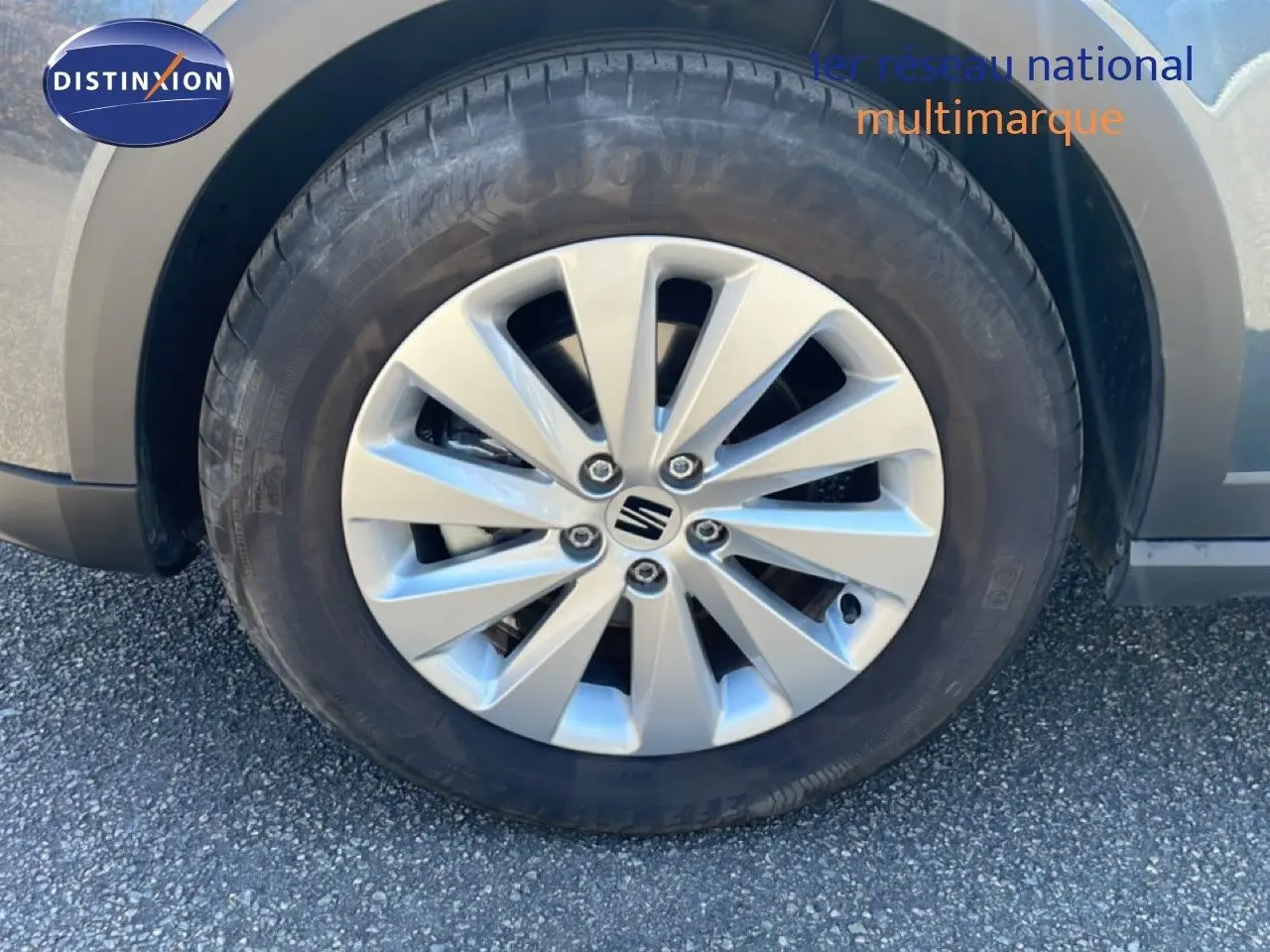 Gros plan sur la roue avant droite d’un SEAT Arona gris Magnetic Metal avec jante alliage 16 pouces et logo central.