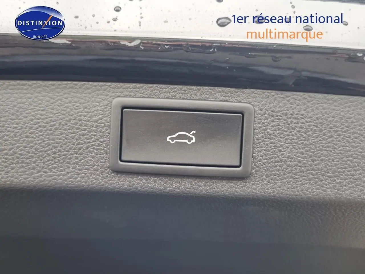 Bouton d'ouverture électrique du coffre sur tableau de bord noir d'un Skoda Karoq 1.5 TSI 2025.