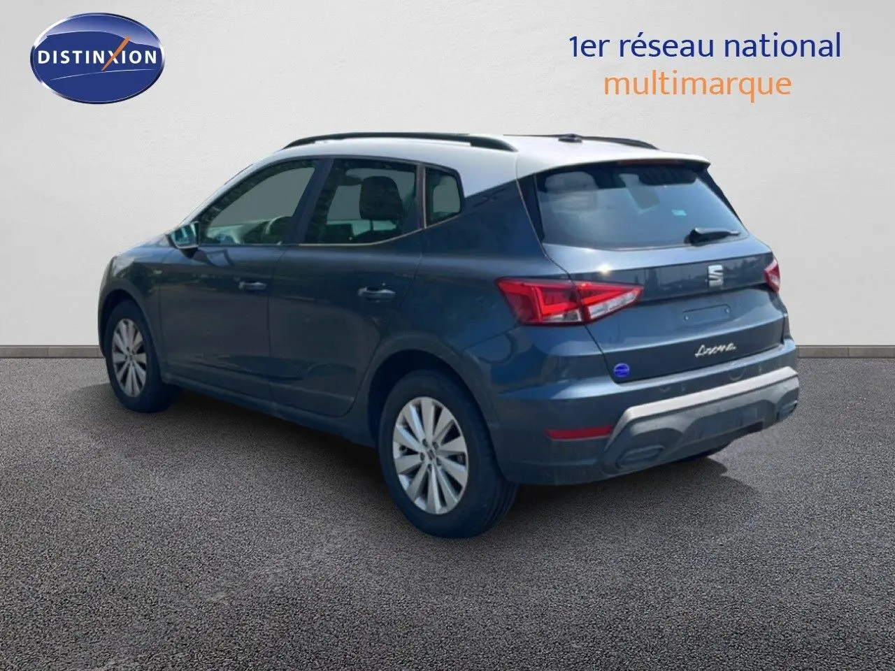 Vue 3/4 arrière d'un SEAT Arona gris Magnetic Metal avec toit noir, mettant en valeur ses feux arrière et son design compact.