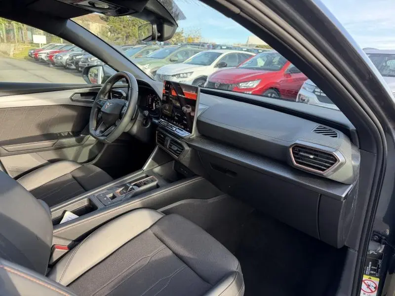 Intérieur côté conducteur du SEAT LEON 2025 gris métallique, avec tableau de bord moderne et écran tactile central.