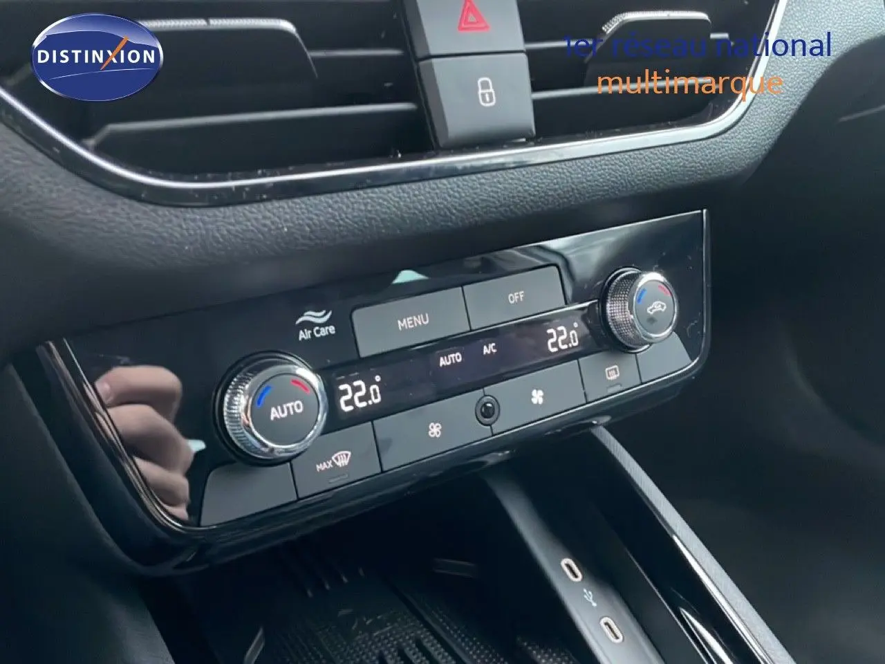 Gros plan sur la console centrale du Skoda Kamiq gris graphite, montrant les commandes de climatisation digitale à 22°C.