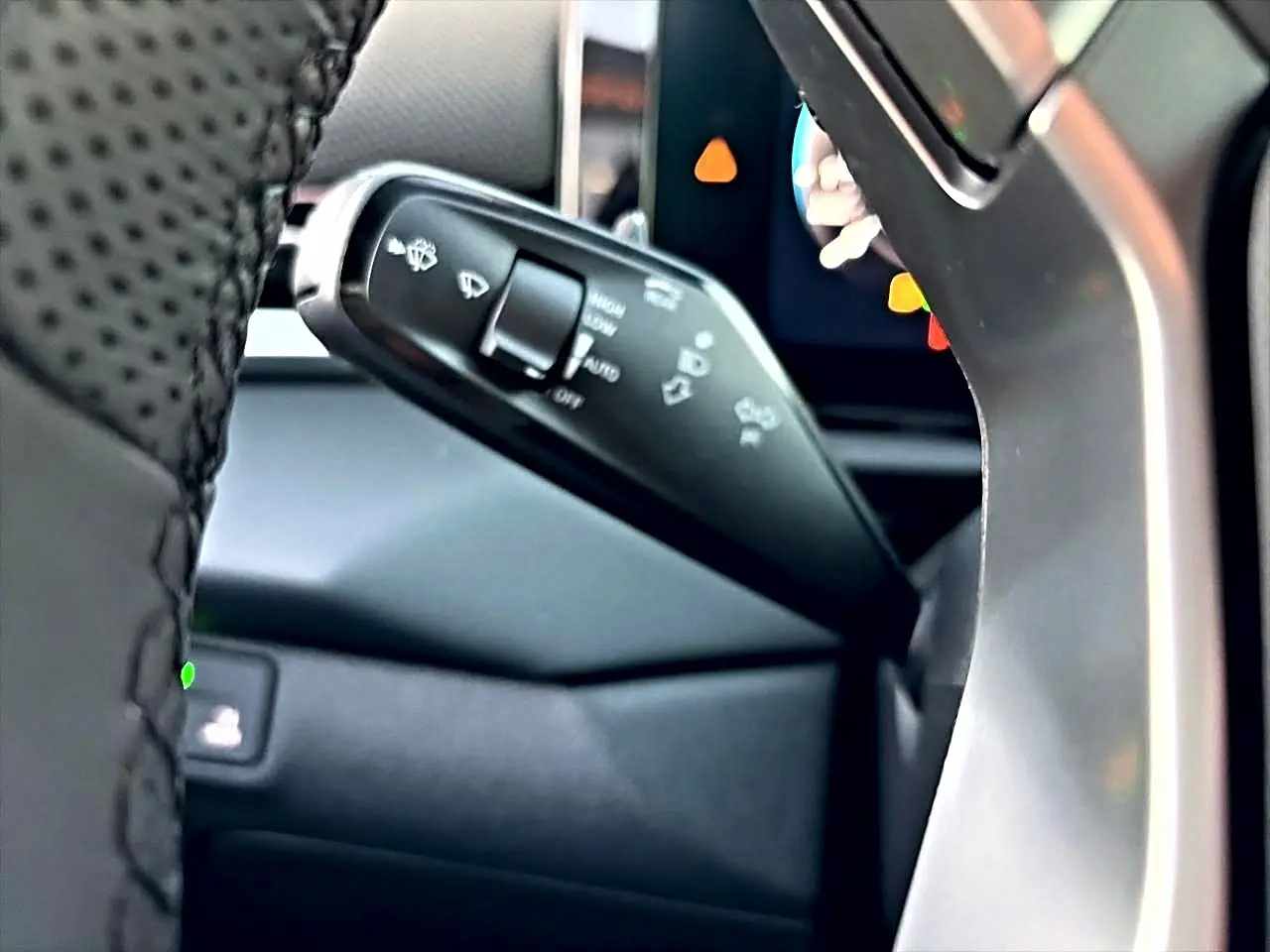 Gros plan sur la manette de commande des essuie-glaces du Volkswagen T-Roc 2026, intérieur noir et volant cuir.