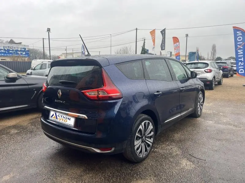 Renault Grand Scenic bleu Cosmos vu en 3/4 arrière droit, avec feux arrière LED et jantes alliage visibles.