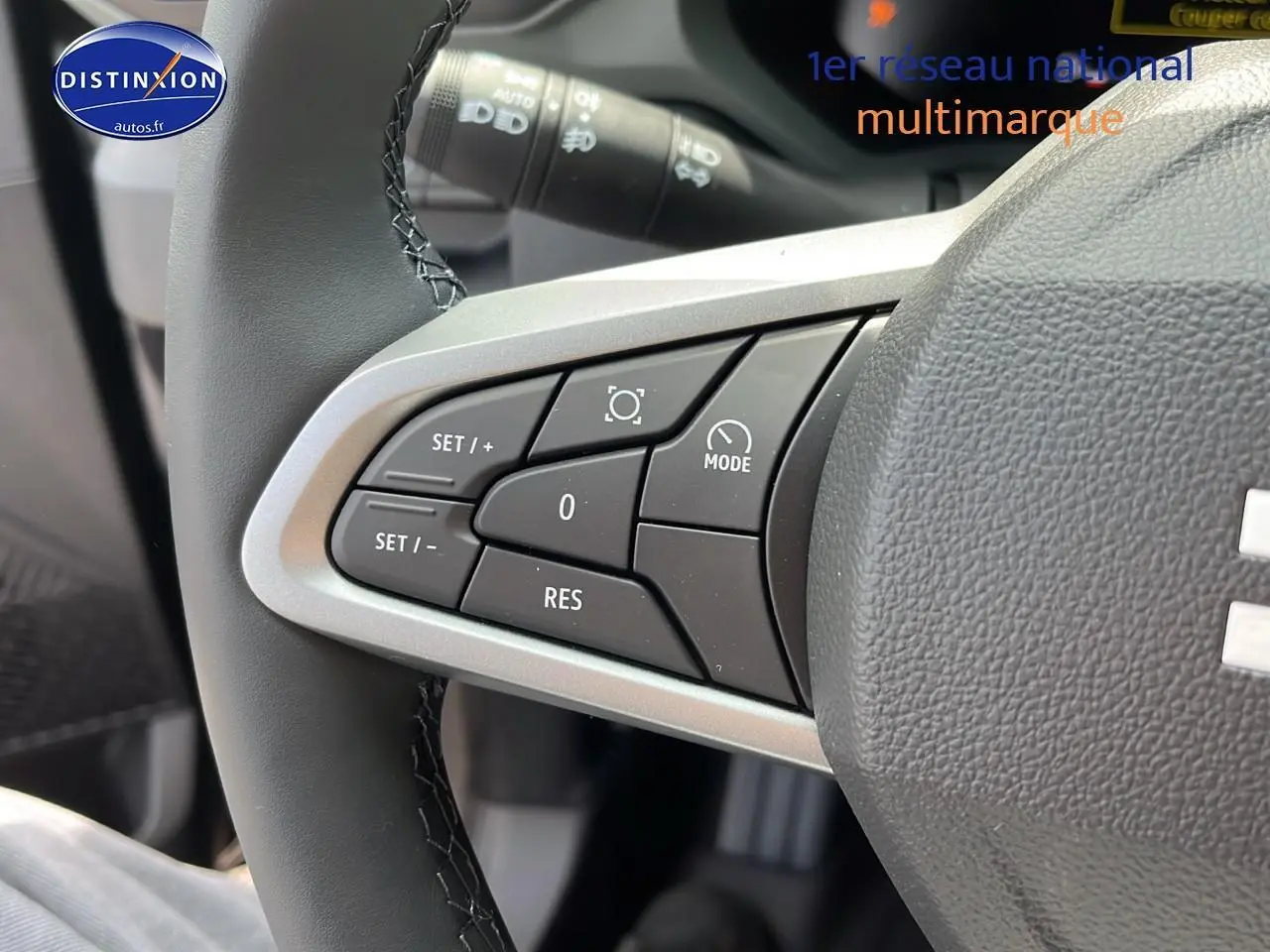 Gros plan sur les commandes multifonctions du volant côté gauche du Dacia Duster 2025 noir, version Expression 4x2.