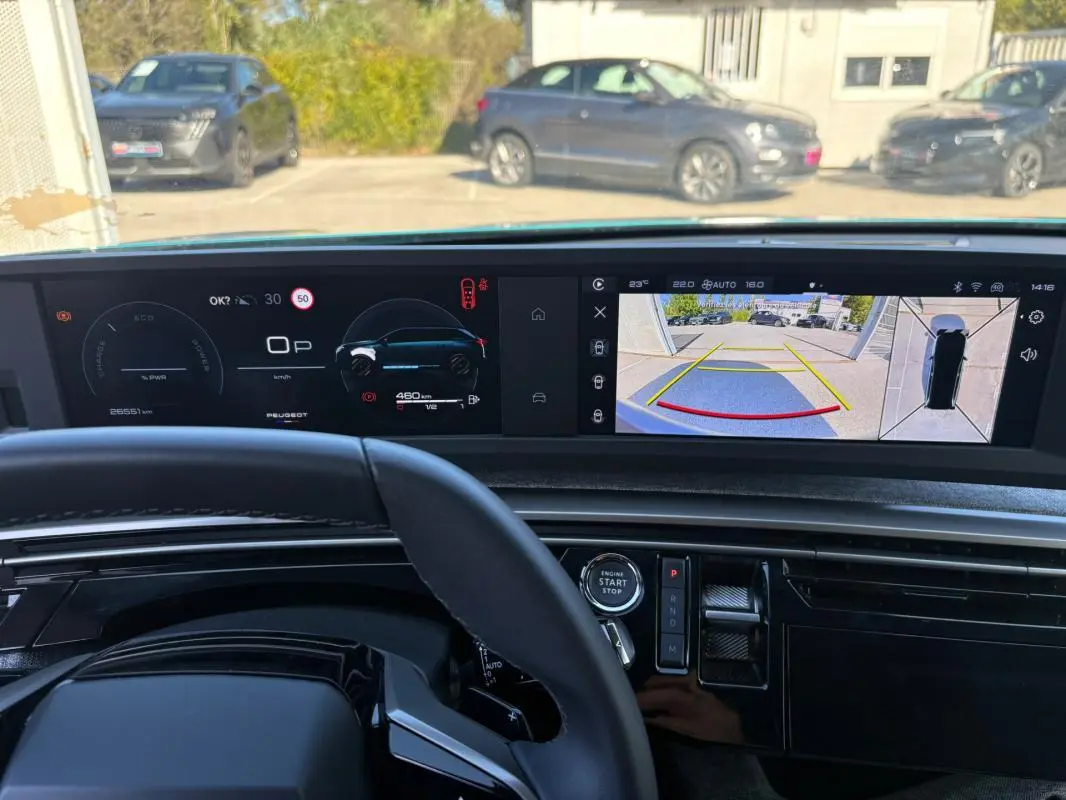 Vue intérieure du tableau de bord du Peugeot 5008 Hybrid 145 ch 2025, avec écran numérique et caméra de recul affichée.